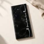 Black Marble Custom Name Mobile Skin — flat lay showing black marble with subtle grey veins, white hearts and cursive sample name