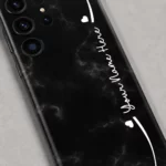 Black Marble Custom Name Mobile Skin — name detail showing black marble with subtle grey veins, white hearts and cursive sample name