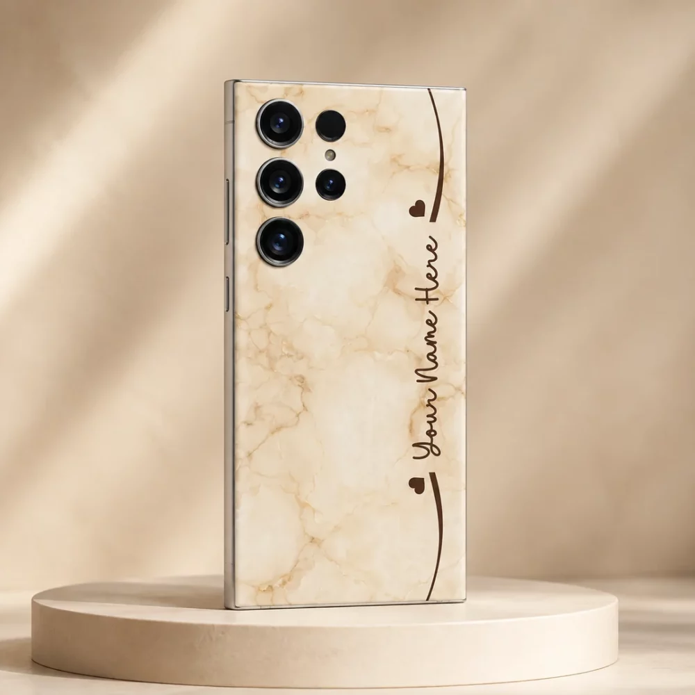 Cream Marble Custom Name Mobile Skin — angled view showing warm cream marble with brown hearts and cursive sample name