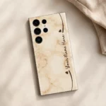Cream Marble Custom Name Mobile Skin — flat lay showing warm cream marble with brown hearts and cursive sample name