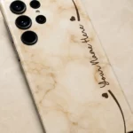 Cream Marble Custom Name Mobile Skin — name detail showing warm cream marble with brown hearts and cursive sample name