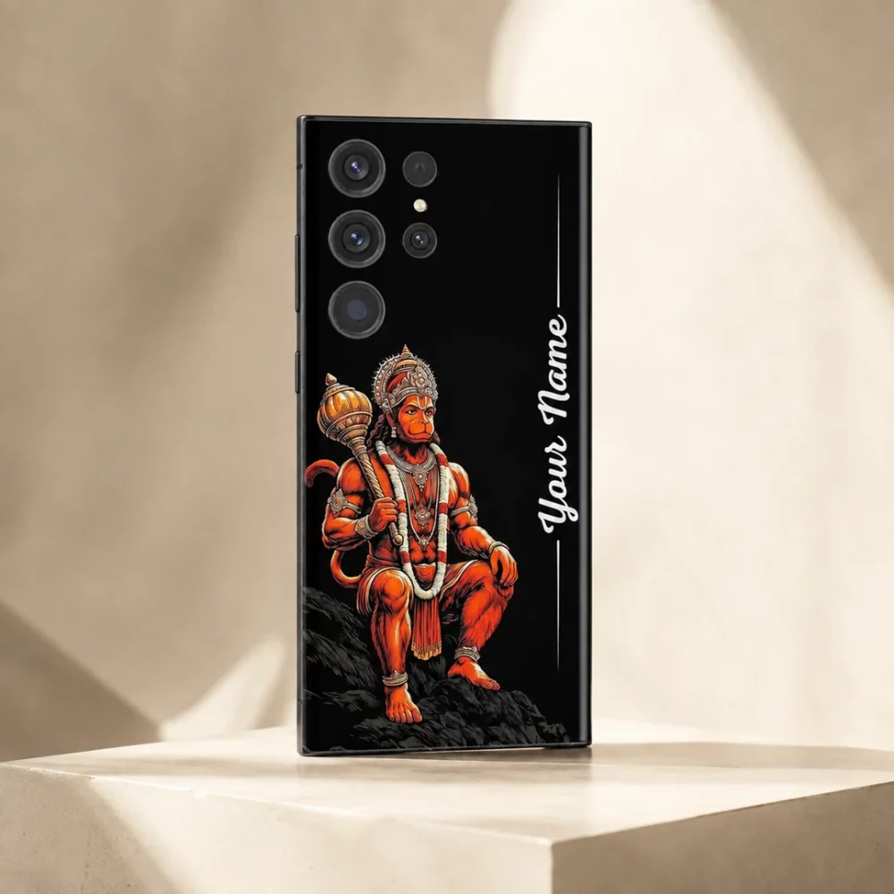 Lord Hanuman Custom Name Mobile Skin — angled view showing seated orange Hanuman with crown and mace on black, beside vertical white sample name