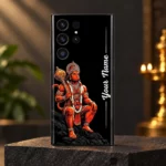 Detailed orange Hanuman crown and golden gada artwork with Your Name lettering on black mobile skin