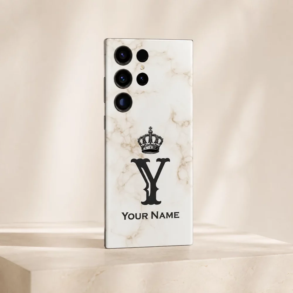 Royal White Marble Custom Name Mobile Skin — angled view showing white marble with a black crown, Y monogram and sample name