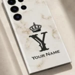 Royal White Marble Custom Name Mobile Skin — name detail showing white marble with a black crown, Y monogram and sample name