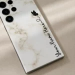 White Marble Butterfly Custom Name Mobile Skin — name detail showing white marble with a black butterfly and vertical cursive personalised name