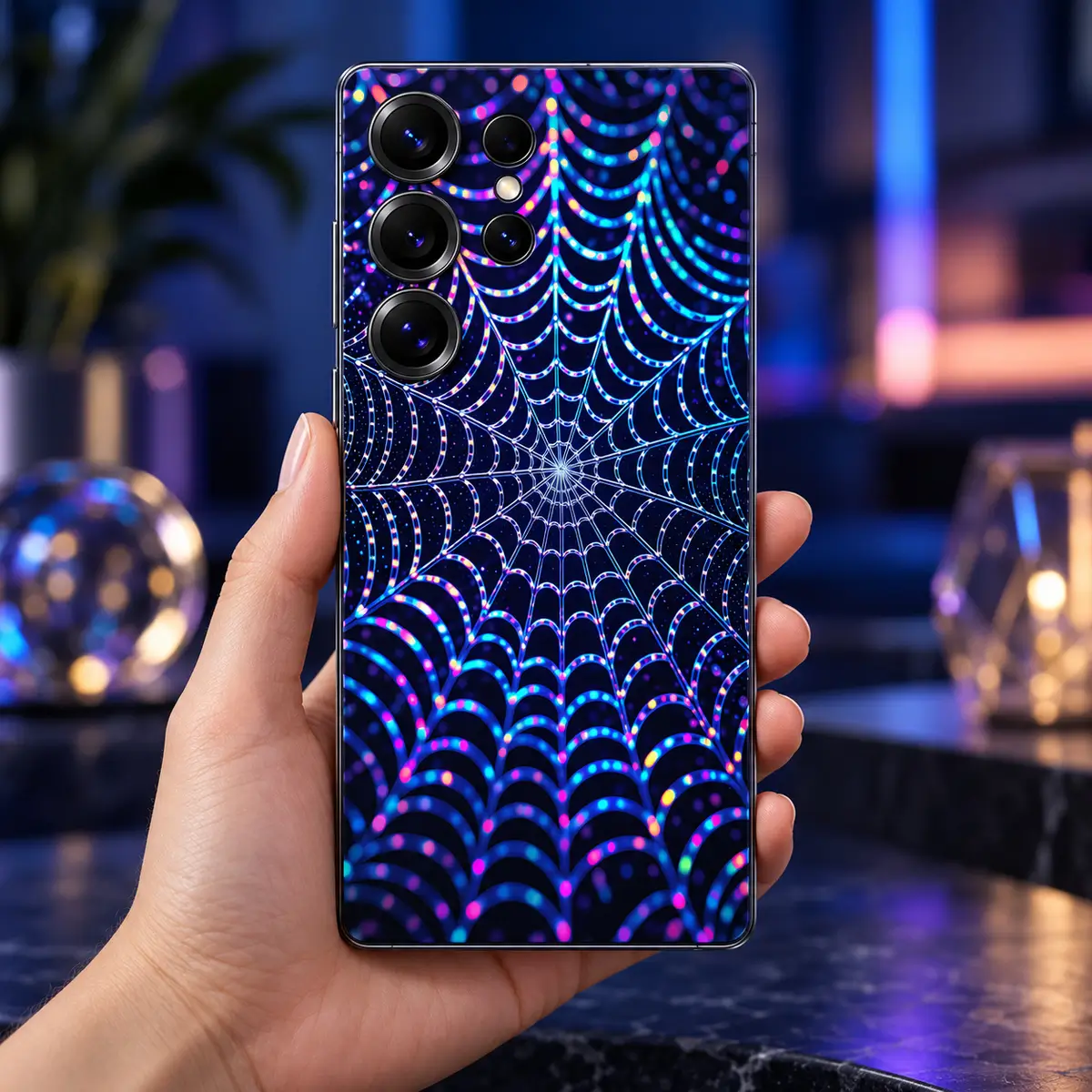 Neon Spider Web Mobile Skin – in-hand lifestyle view Neon Spider Web Mobile Skin in-hand lifestyle view